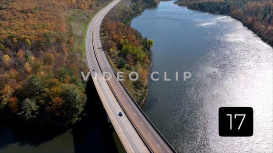 CLIP 17 - Tioga Dam and Reservoir, PA cars and trucks driving beside reservoir in sunlight
