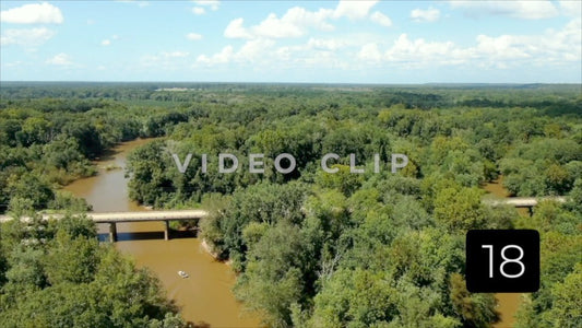 CLIP 18 - Montezuma, GA fisherman in boat motors past train bridge on Flint River