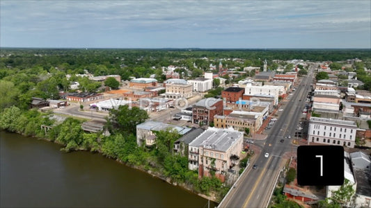 CLIP 1 - Selma, AL aerial landscape flying over Edmund Pettus Bridge to city streets