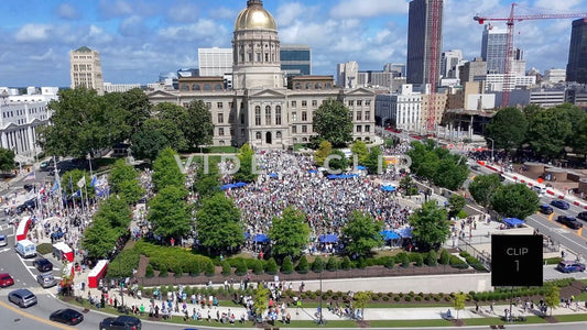 CLIP 1 - Atlanta, GA No Kings Protest - Aerial flight to Georgia State Capitol as camera tilts down to protesters