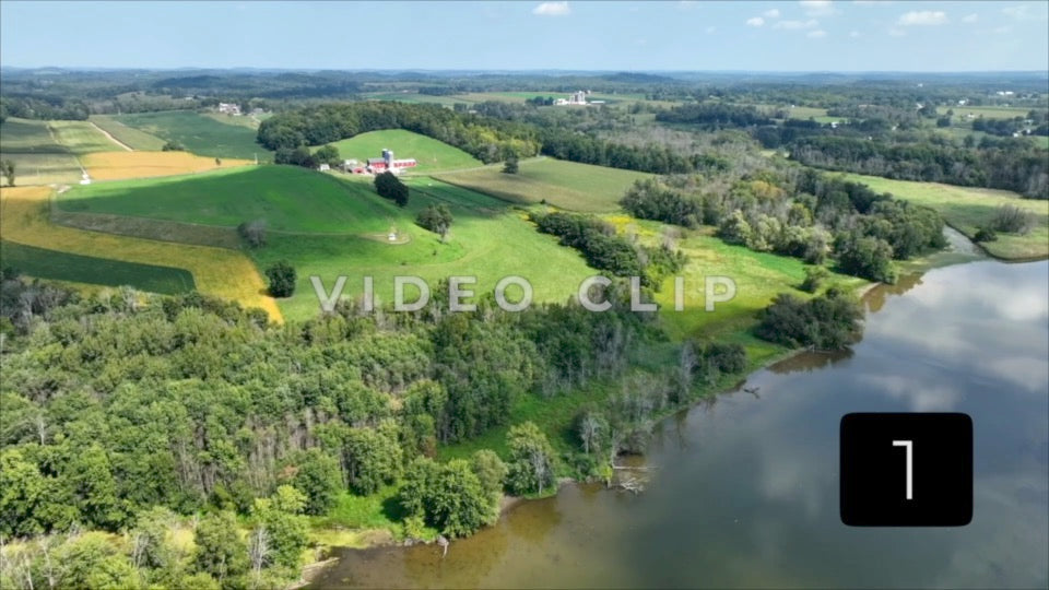 CLIP 1 - Green rolling hills with Farm and fields beside river in New York State countryside