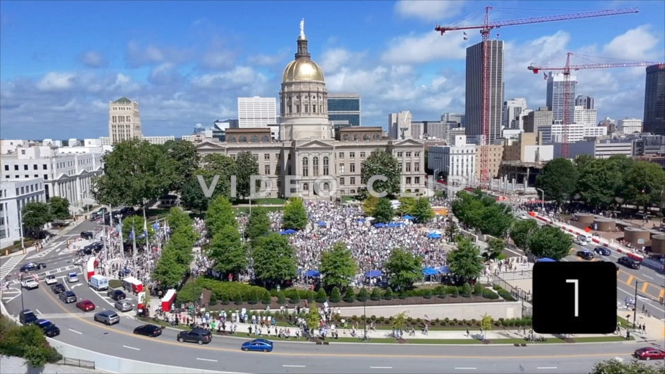 CLIP 1 - Atlanta, GA No Kings Protest - Aerial flight to Georgia State Capitol as camera tilts down to protesters