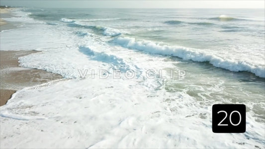 CLIP 20 - Litchfield Beach, SC low flight over breaking wave in morning sunlight