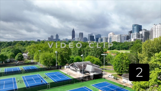 CLIP 2 - Atlanta, GA Vol. 2 - Aerial rising up over Tennis courts to city skyline from Piedmont Park