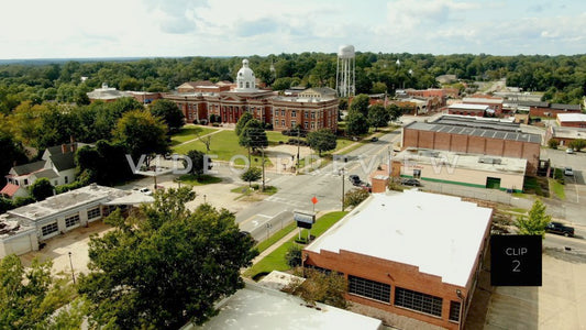 CLIP 2 - Eatonton, GA  - Putnam County Clerk of Courts - aerial lowering down behind downtown buildings