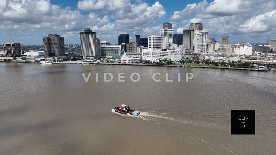CLIP 3 - New Orleans, LA tug boat on Mississippi river passing by city skyline