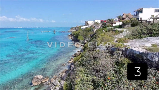 CLIP 3 - Isla Mujeras, Mexico rising up from cliffside to reveal coastal vacation homes