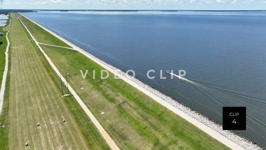 Stock video CLIP 4 - Lake Marion, SC boat cruising by reservoir earthen dam wall 