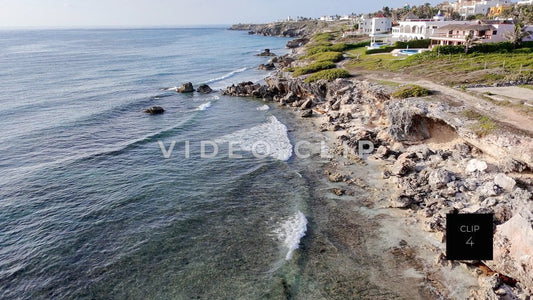CLIP 4 - Isla Mujeras, Mexico low flight along rocky shoreline as gentle waves break onshore