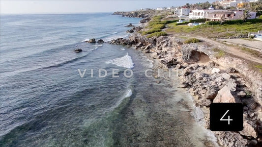 CLIP 4 - Isla Mujeras, Mexico low flight along rocky shoreline as gentle waves break onshore