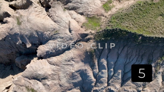 CLIP 5 - Badlands, SD close drone flight over Butte top to observe erosion