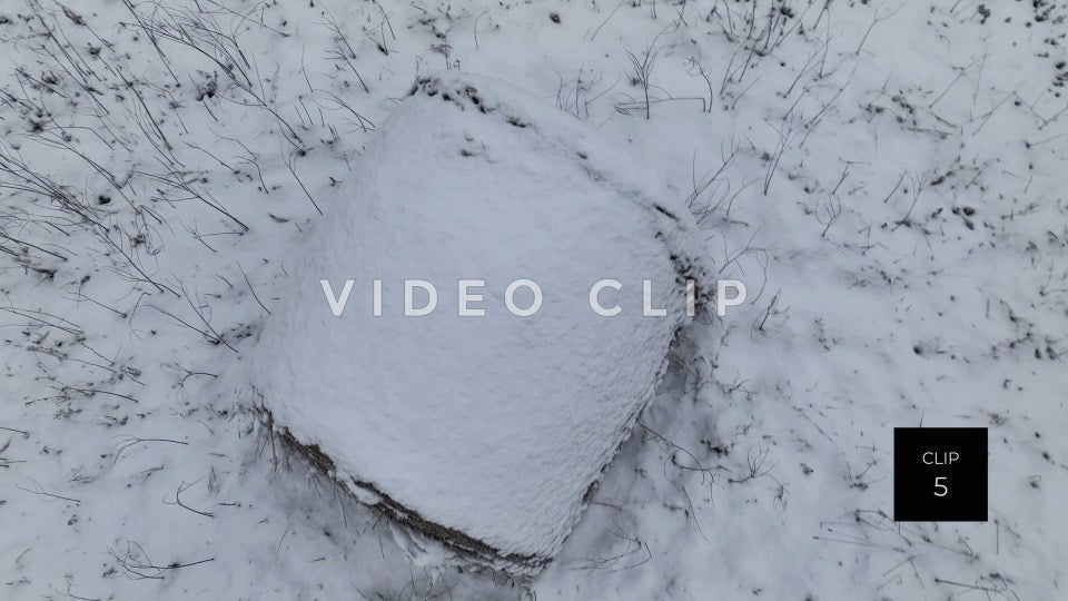 CLIP 5 - Looking down on snow covered hay bale in pasture during Winter