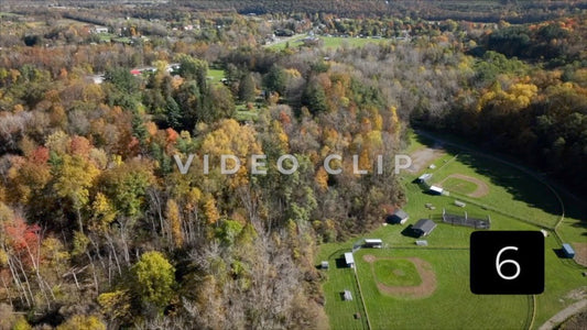 CLIP 6 - Tioga-Hammond Lakes, PA rising over green park with baseball field to view Tioga, GA