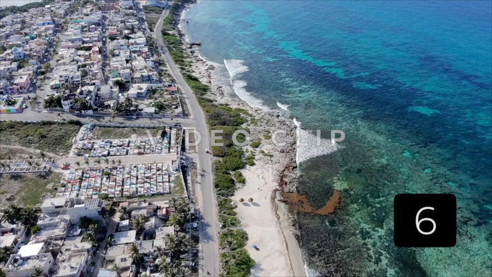 CLIP 6 - Isla Mujeras, Mexico aerial flight along coast over road and vacation homes