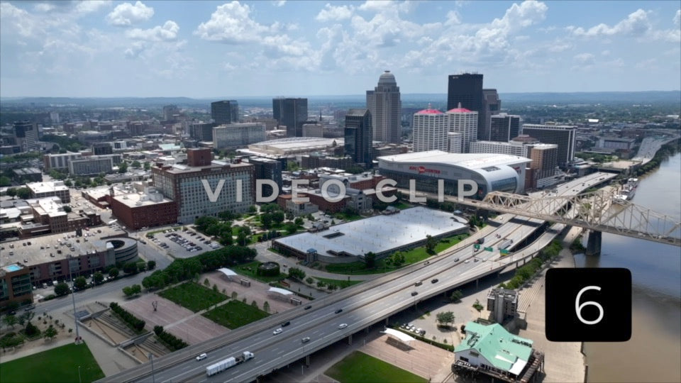 CLIP 6 - Louisville, KY cars and truck driving past downtown beside Ohio River