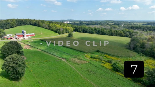 CLIP 7 -Car passing by farm house and pastures in New York State countryside