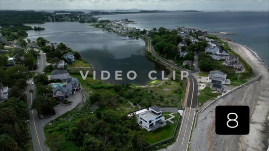 CLIP 8 - Boston, MA city skyline on horizon with houses in foreground along Massachusetts Bay