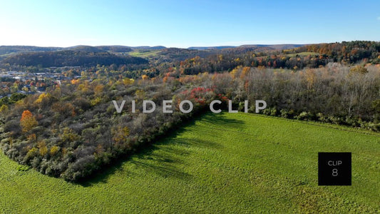CLIP 8 - Wellsboro, PA rising up over green field to reveal downtown