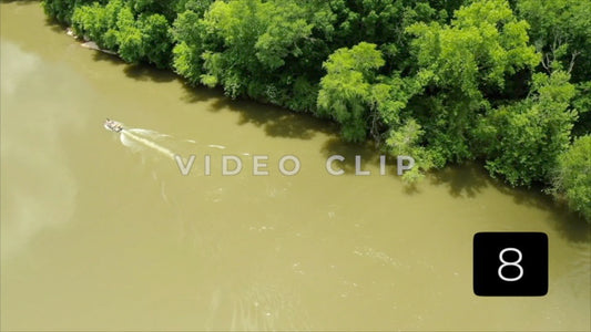 CLIP 8 - Chattahoochee River - fisherman motoring up river beside green forest at Franklin, GA