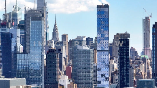 Photo - New York City, NY Glass buildings reflecting blue sky