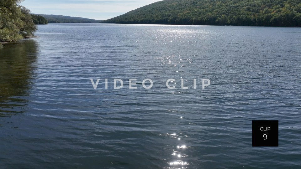 Stock video CLIP 9 - Canadice Lake, NY low flight over peaceful Finger Lake with sunlight