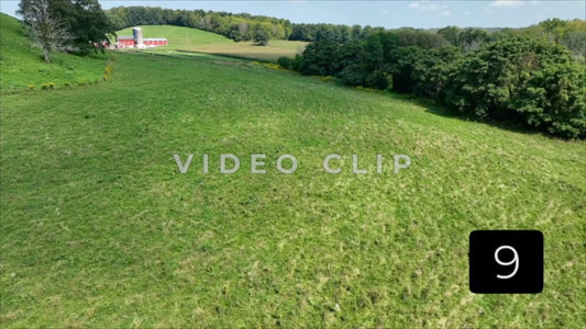 CLIP 9 - Slowly lowering towards green pasture with Farm house in New York State countryside