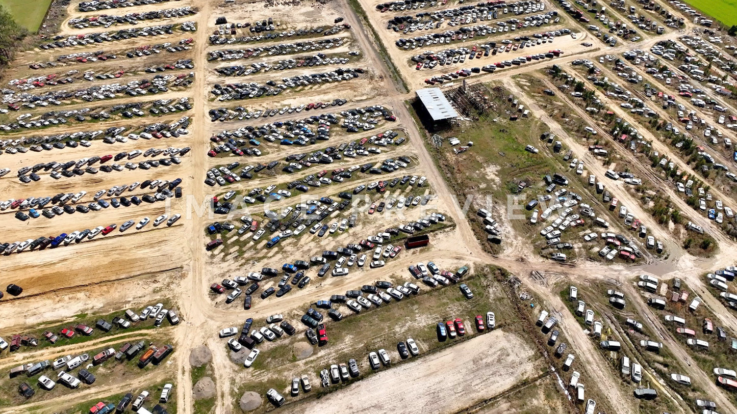 4k Still Frame - Hemingway, SC looking down on wrecked cars in salvage yard