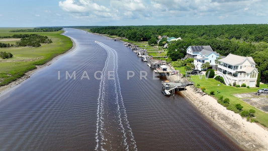 4k Still Frame - McClellanville, SC boat motoring past homes along the Intracoastal Waterway