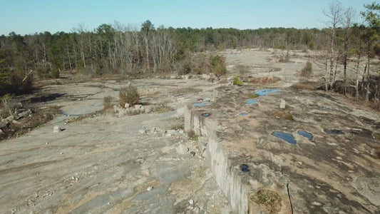 Video - Two hikers walking through quarry ruins in Arabia Mountain Park in Georgia