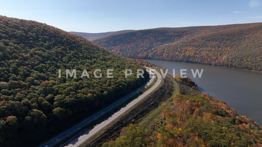 4k Still Frame - Cars traveling on highway past Tioga Reservoir and mountains in Pennsylvania during Fall