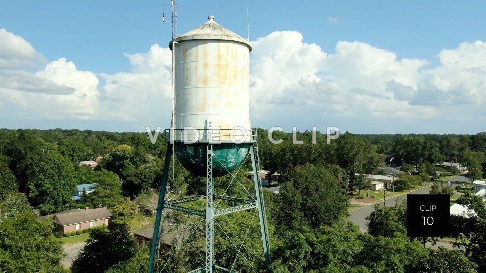 CLIP 10 - Montezuma, GA rising up past old watertower towards blue sky and clouds