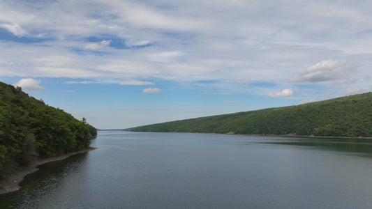 Video - Timelapse - Rising above peaceful lake and mountains with clouds passing at Hemlock Lake, NY