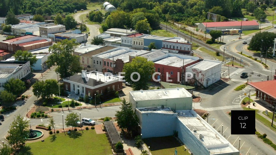 CLIP 12 - Montezuma, GA flying towards downtown with Post Office is foreground