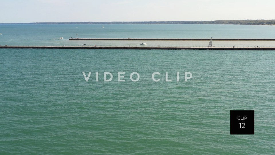 CLIP 12 - Boats motoring on Genesee river past Charlotte Pier at Ontario Beach Park Rochester, NY