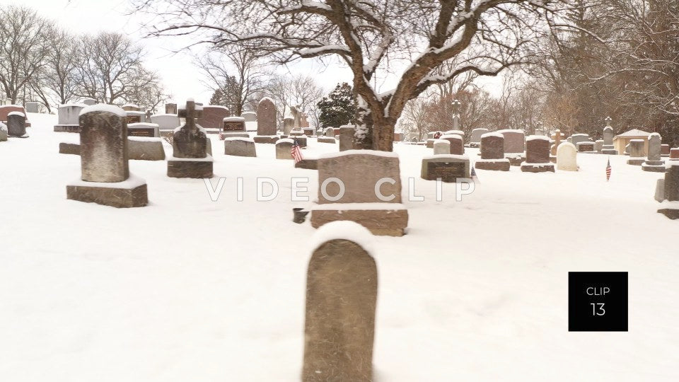 CLIP 13 - Cemetery grave stones covered in snow during Winter freeze