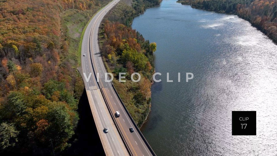 CLIP 17 - Tioga Dam and Reservoir, PA cars and trucks driving beside reservoir in sunlight