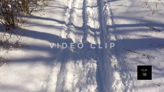 CLIP 18 - Close up of snow mobile trail in public park during Winter