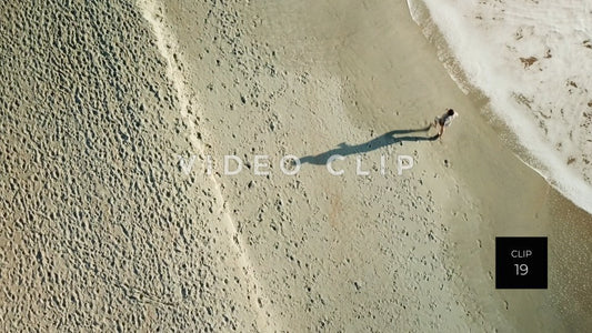 CLIP 19 - Litchfield Beach, SC person jogging on beach in morning sunlight