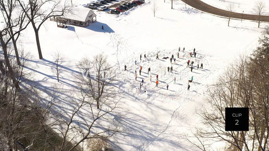 CLIP 2 - People enjoying park play during Winter with snow