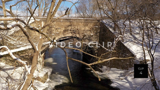 CLIP 4 - Snow covered train bridge with stone arch in Winter