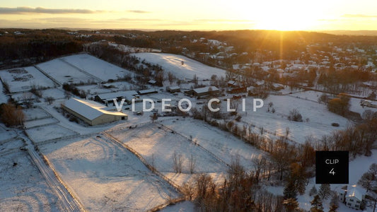 CLIP 4 - Flying over horse farm during winter with snow at sunset