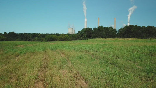 Up from grass field to view coal fired power plant Scherer in Juliette Georgia