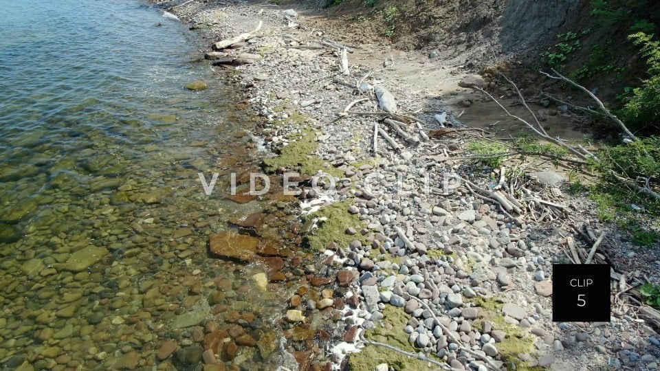 CLIP 5 - Lake Ontario Webster, NY close up of shoreline with driftwood and rocks