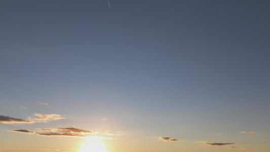 Video - Timelapse - Sunset in lower third of screen with clear sky above