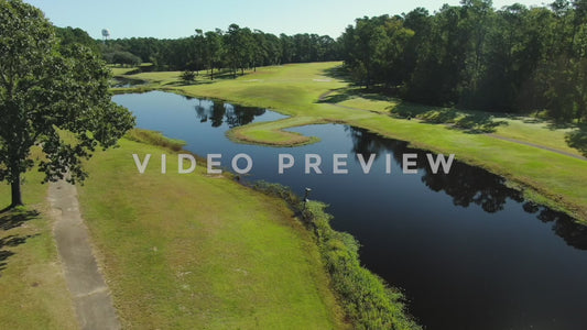 Video - Golf Course aerial flight over lake and fairway towards green