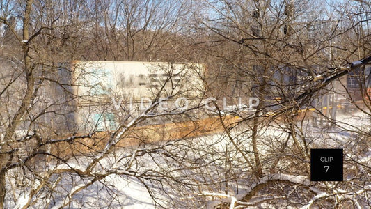 CLIP 7 - Train with shipping containers moving through Winter landscape