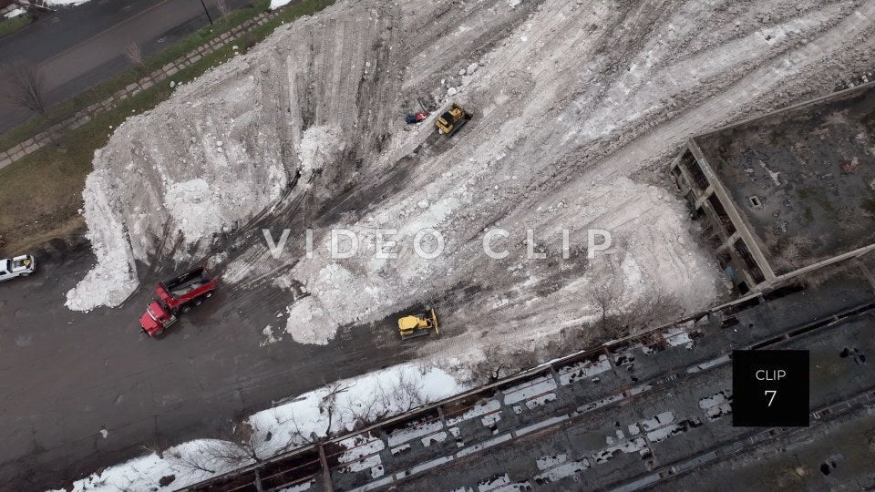 CLIP 7 - Buffalo, NY city workers deposit snow from streets beside abandoned building