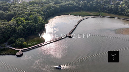 CLIP 7 - Rochester, NY Genesee Riverway Trail boardwalk in afternoon sunlight with boat passing by