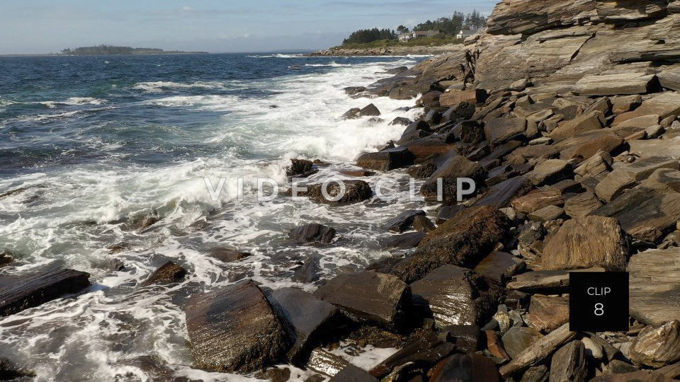 CLIP 8 - Maine Coast slow flight over waves breaking on rocky shore with view of houses