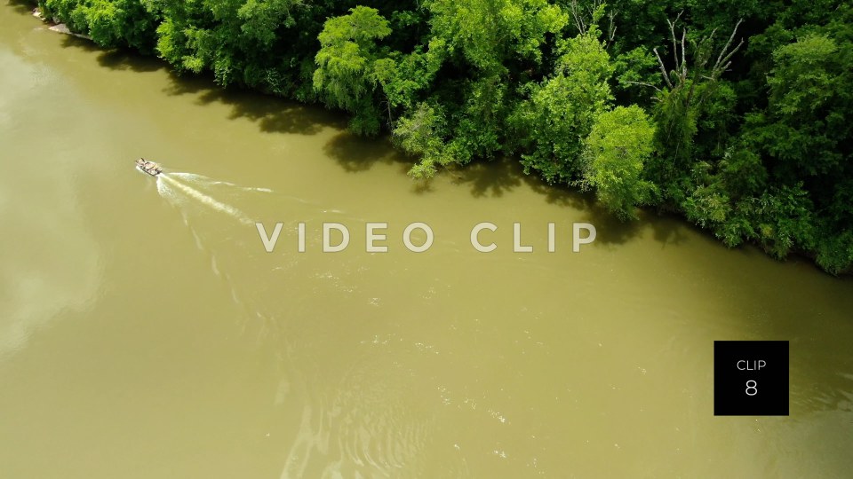 CLIP 8 - Chattahoochee River - fisherman motoring up river beside green forest at Franklin, GA